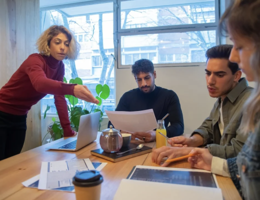 2 Men and a Woman at a Small Conference Table